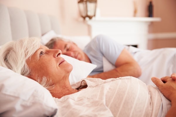 Dangers of not getting enough sleep Worried Senior Woman Lying Awake In Bed