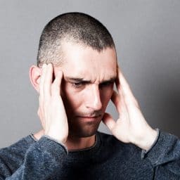 man covering his ears