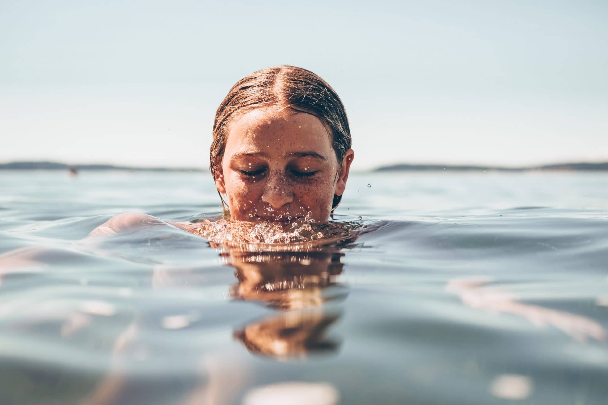 Preventing Swimmer’s Ear woman with her head half way in water