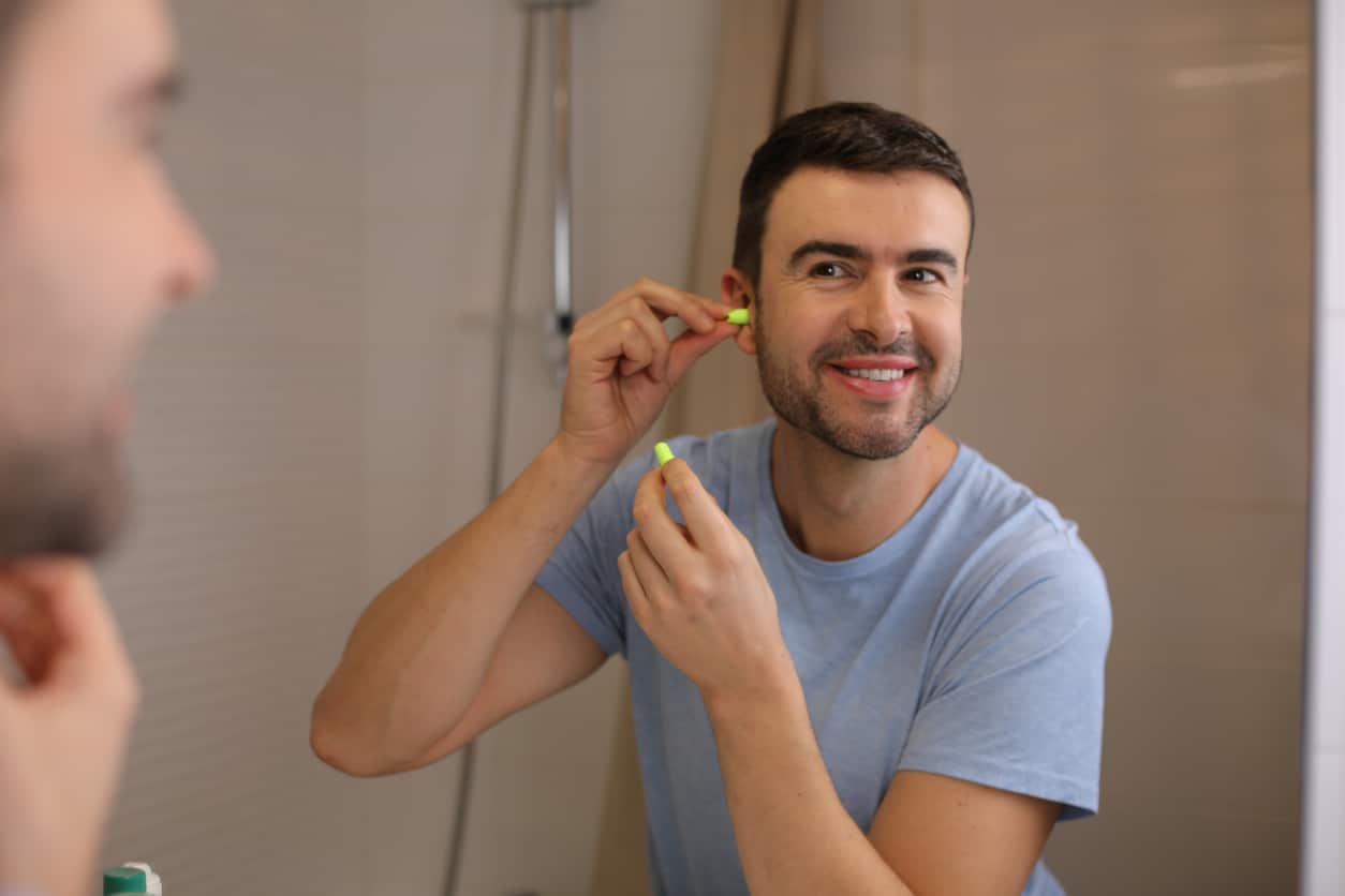 Man protects hearing at home