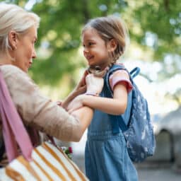 A touching moment as a mother helps her daughter get ready for school, embodying care, love, and support.